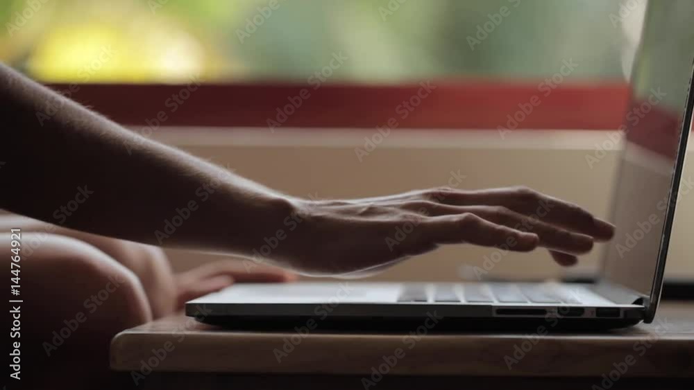Close-up of female hands opens and switch on the laptop