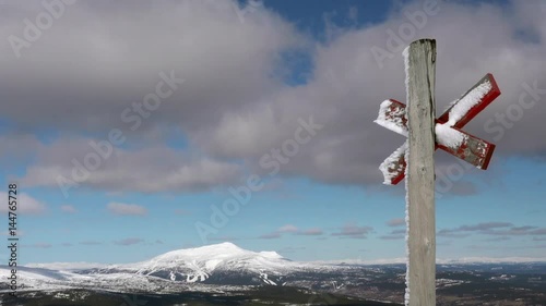 Swedish ski resort Are with a route marker for skiers in the foreground.  photo