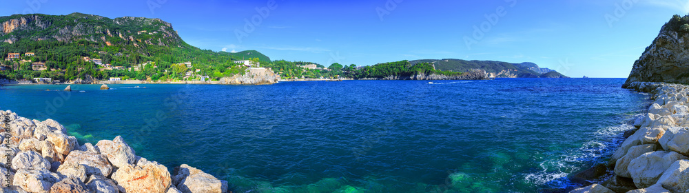 Beautiful summer panoramic seascape. View of the coastline into the sea bays with crystal clear azure water. Paleokastrica. Corfu. Ionian archipelago. Greece.