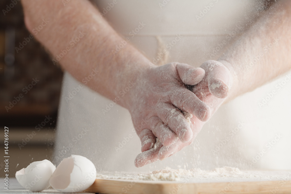 Mixing flour and yeast in the bowl by hand,bread cooking