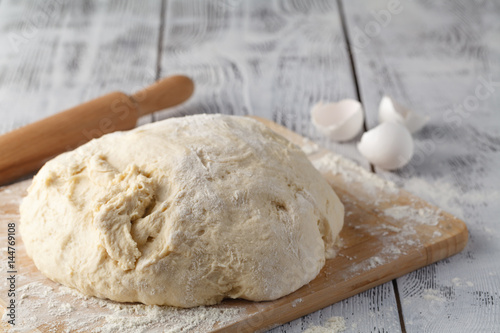 fresh raw dough ball on white background, photo