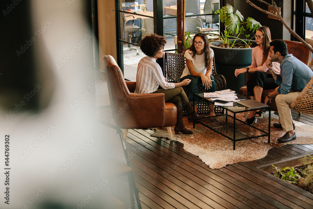 Creative people doing a brainstorming meeting in a modern office