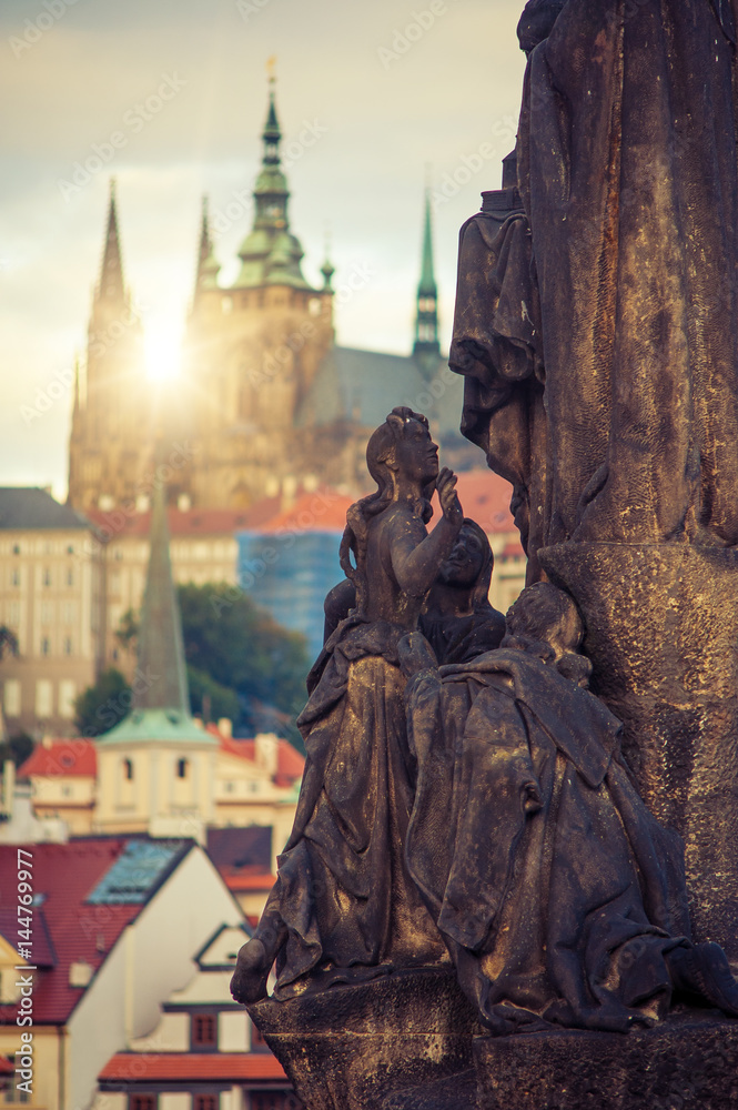 Beautiful morning at Charles bridge with its statuette in autumn time