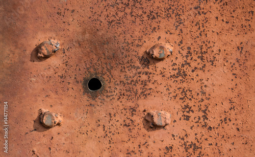 abstract background with hole and screws, and texture rust orange-brown with spots