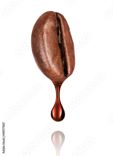 Drop of coffee dripping from coffee seed on white background