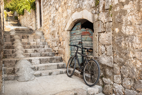 Single bicycle in a steep stepped Dubrovnik alleyway, Croatia photo