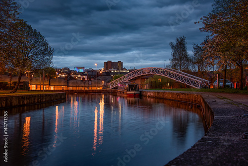 A night shot of the cauldon canal with a bridge crossing at Etruria, Stoke on trent photo