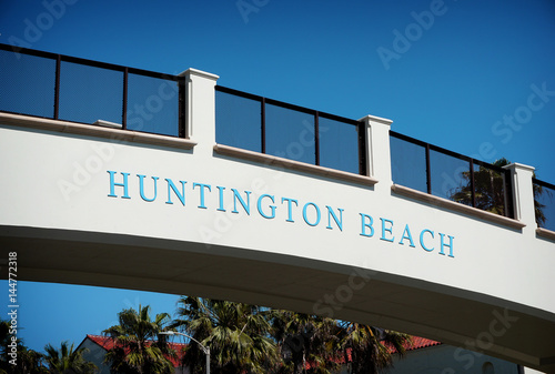 huntington beach sign on bridge over pacific coast highway photo