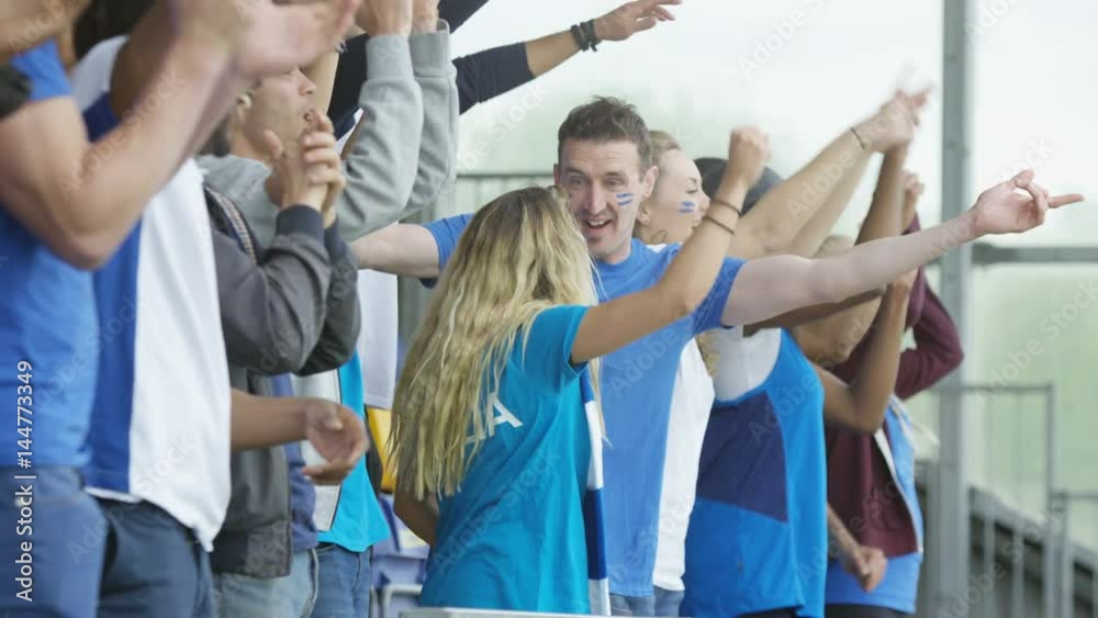 Crowd cheering at sports event, Italian fans wearing team colours Crowd cheering at sports event, Italian fans wearing team colours