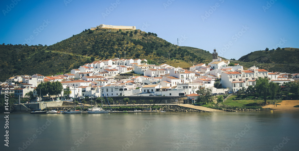 View of the village of Sanlucar on the banks of Guadiana river located in Spain taken from Alcoutim in Portugal. April 2017