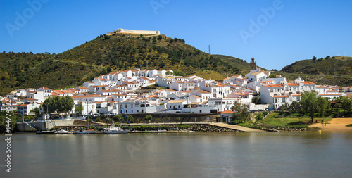 View of the village of Sanlucar on the banks of Guadiana river located in Spain taken from Alcoutim in Portugal. April 2017