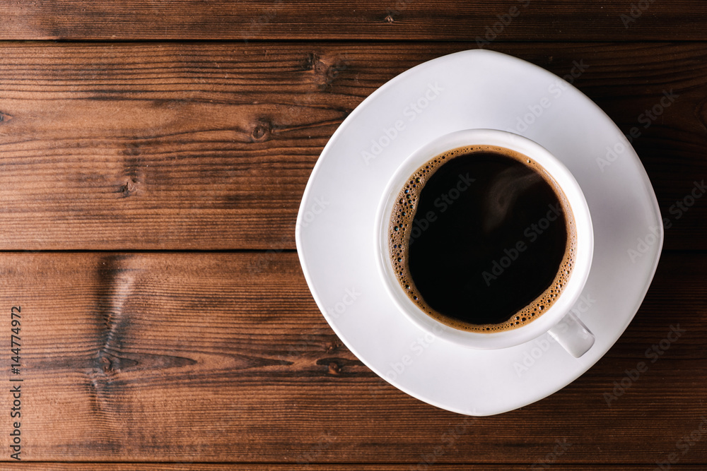 Coffee cup with saucer on wooden table. Coffee cup with saucer on wooden table.