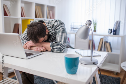 Young businessman sleeping on work