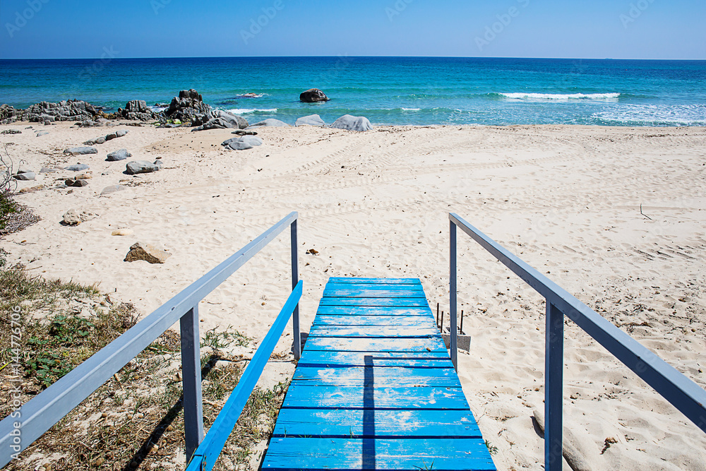 tourquoise wooden pier at Orri beach, Sardinia