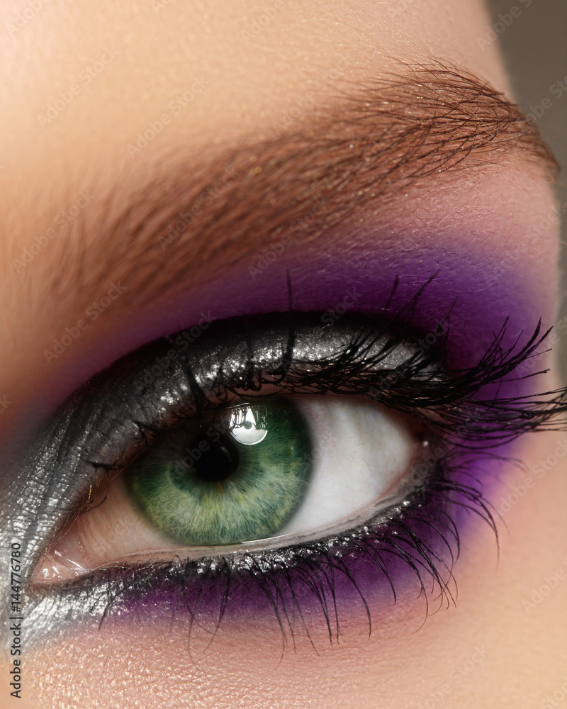 Closeup female eye with fashion bright make-up. Beautiful silver, purple  eyeshadow, glitter, black eyeliner Stock Photo | Adobe Stock