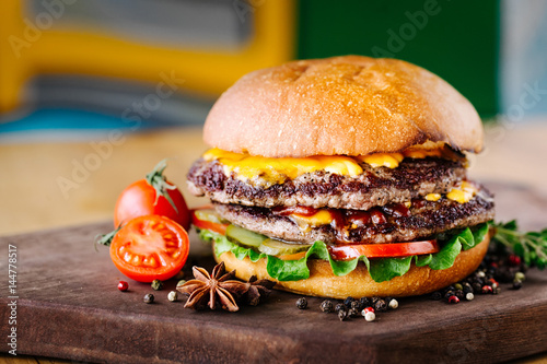 Delicious burgers with beef, tomato, cheese and lettuce photo