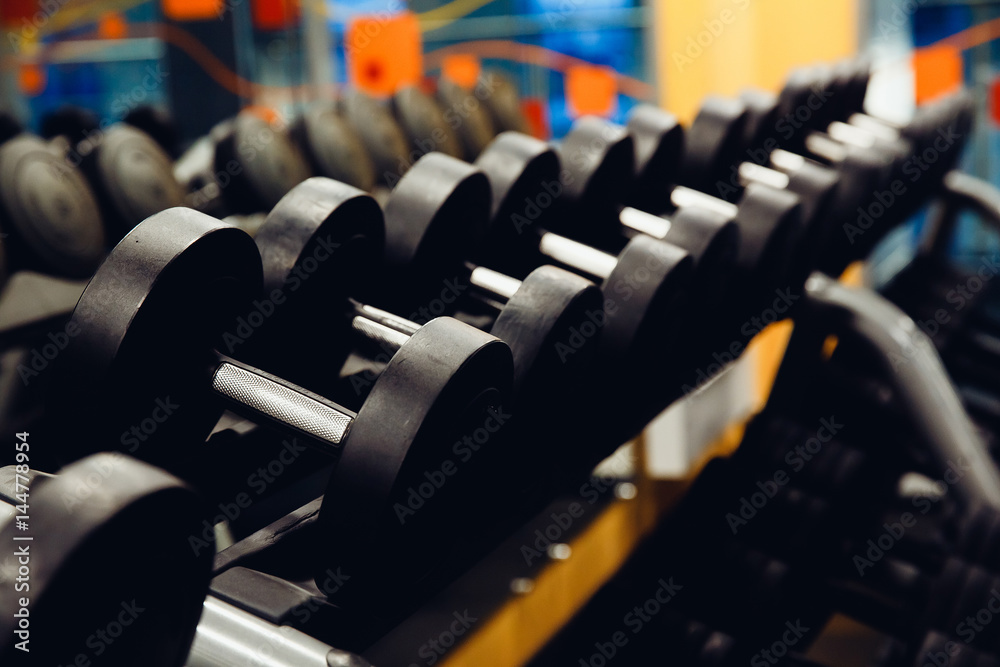 Sports equipment dumbbell rests in a row. high contrast and monochrome color tone.
