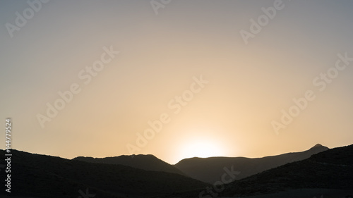 sunset over a dried plain an mountains