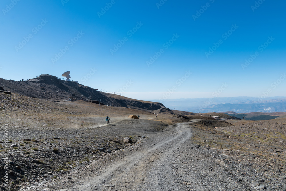 man riding mountain bike from a slope