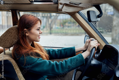 woman in green coat driving a car © SHOTPRIME STUDIO