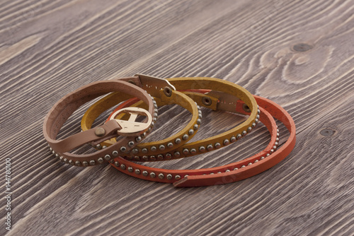 Brown  orange  green bracelet on wooden boards