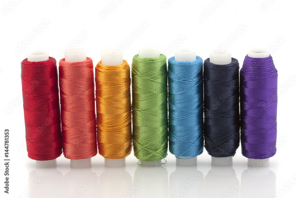 Silk threads on reels, the colors of the rainbow on a white background. Isolated Silk threads on reels, the colors of the rainbow on a white background. Isolated