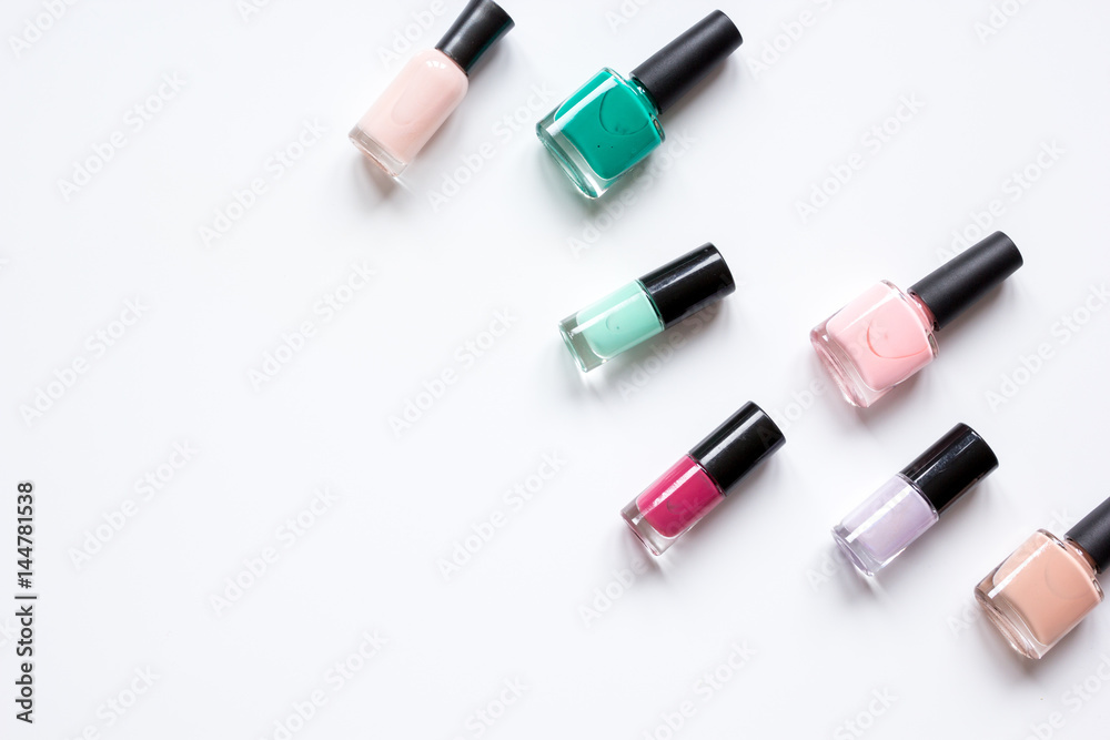 Bottles with nail polish over white background top view mockup