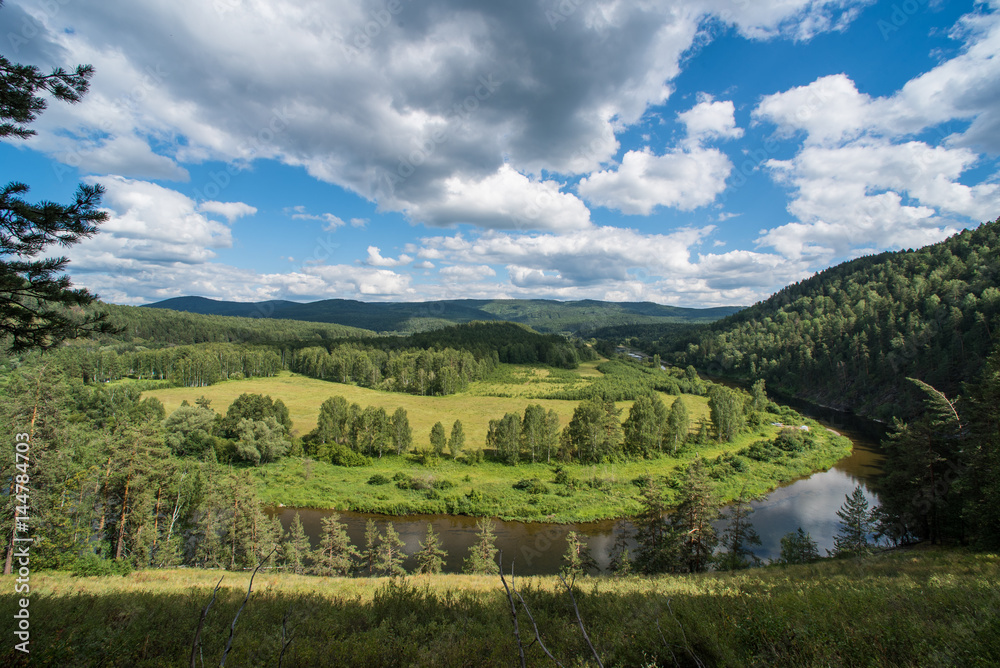 Scenery valley of river Belaya with blue cloudy sky (focus is in the middle)