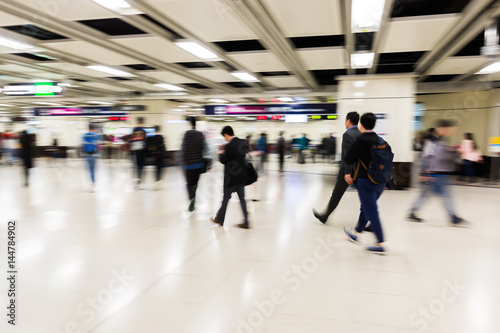 people in an underground station in motion blur