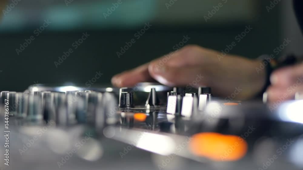 DJ in Night Club Mixing Tracks at a disco party. 4K - easy to crop, rotate and zoom, without losing quality. 4K. DJ in Night Club Mixing Tracks at a disco party. 4K - easy to crop, rotate and zoom, without losing quality. 4K.
