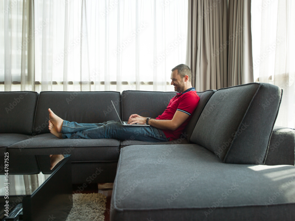 Man using laptop in living room