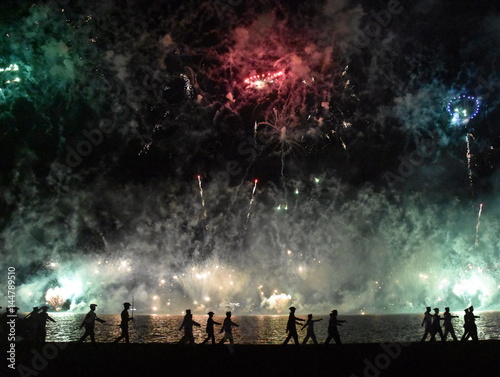 Skyfire 2017 in Canberra, Australia. Fireworks during Canberra's annual SkyFire appear above Lake Burley Griffin. Australian Federation Guard moving away at Gallipoli Reach.