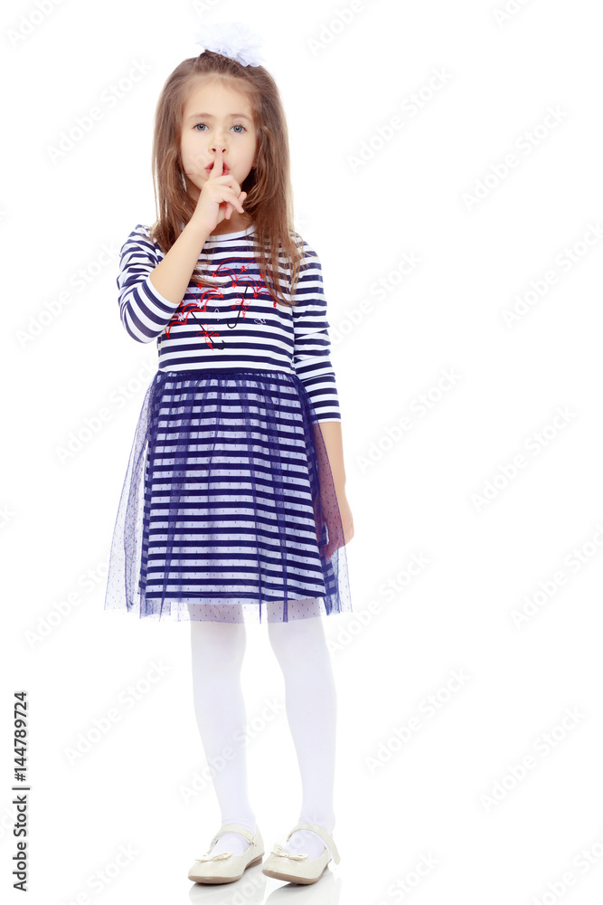 Cute little girl posing in front of the camera. Cute little girl posing in front of the camera.
