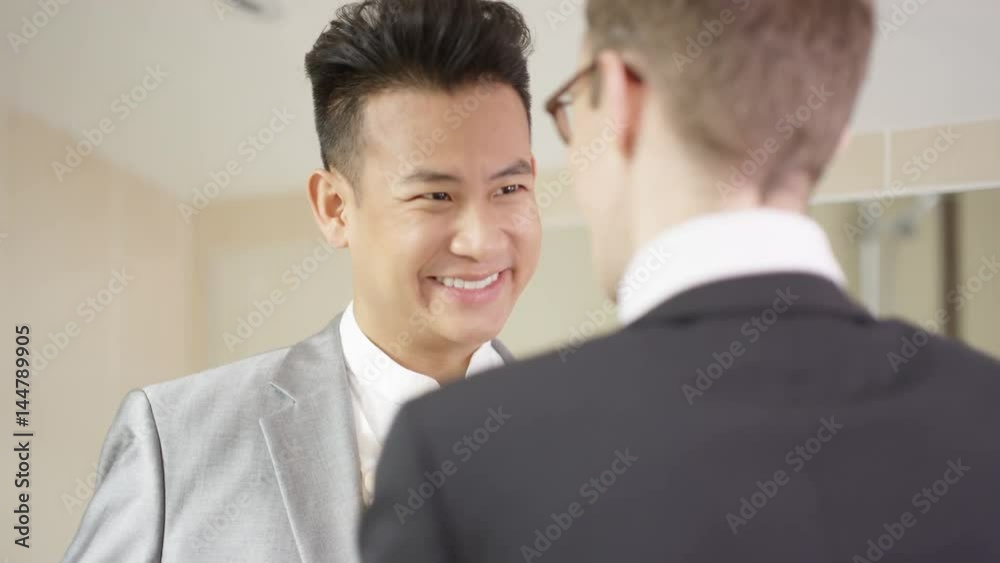 Young gay couple getting ready for wedding day share a kiss Young gay couple getting ready for wedding day share a kiss