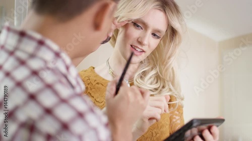  Transvestite man getting ready shares a kiss with his partner photo