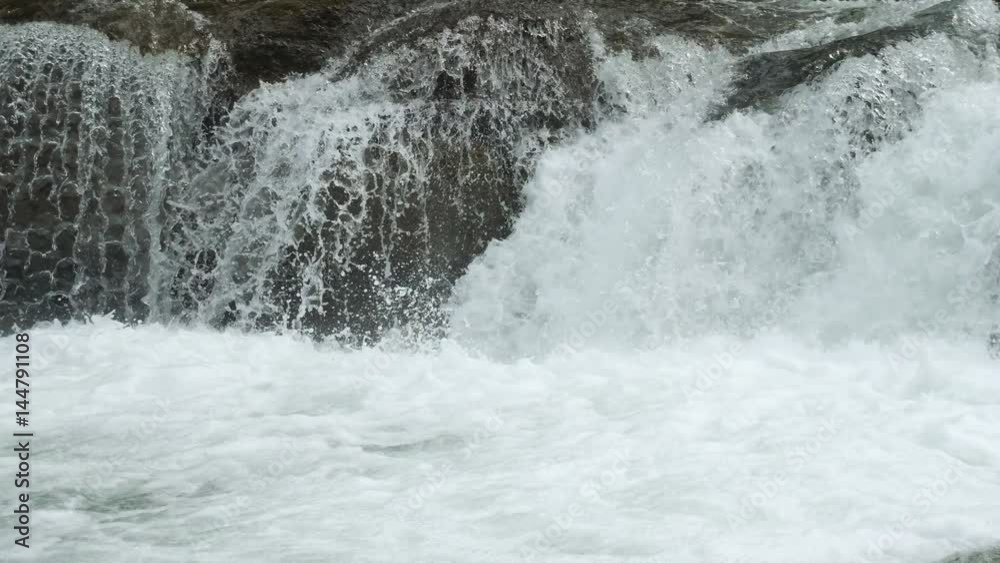 Slow motion water floating down a cascade of a river, close, in 4K Slow motion water floating down a cascade of a river, close, in 4K