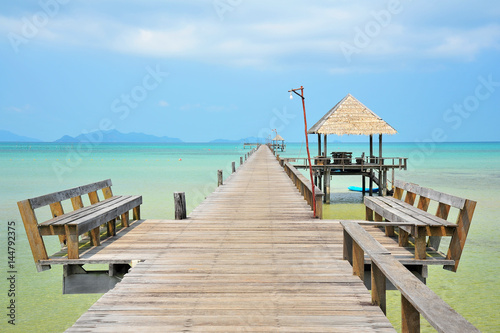 Beach on Tropical Islands with Wooden Piers © karinkamon