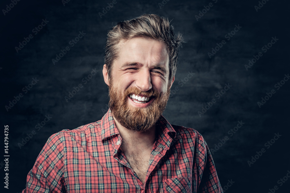 Bearded male dressed in a red fleece shirt makes conversation.