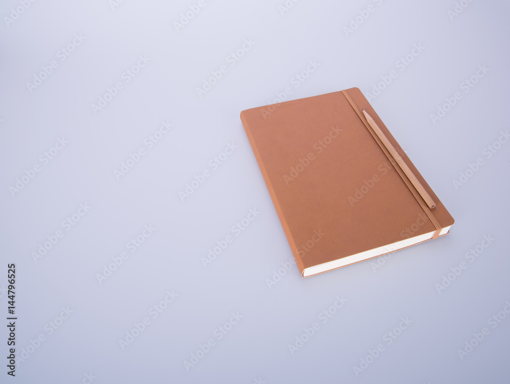 notebook or leather diary and pencil on the blackground. notebook or leather diary and pencil on the blackground.