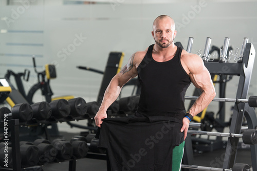 Bodybuilder Posing With T-shirt For Copy Space