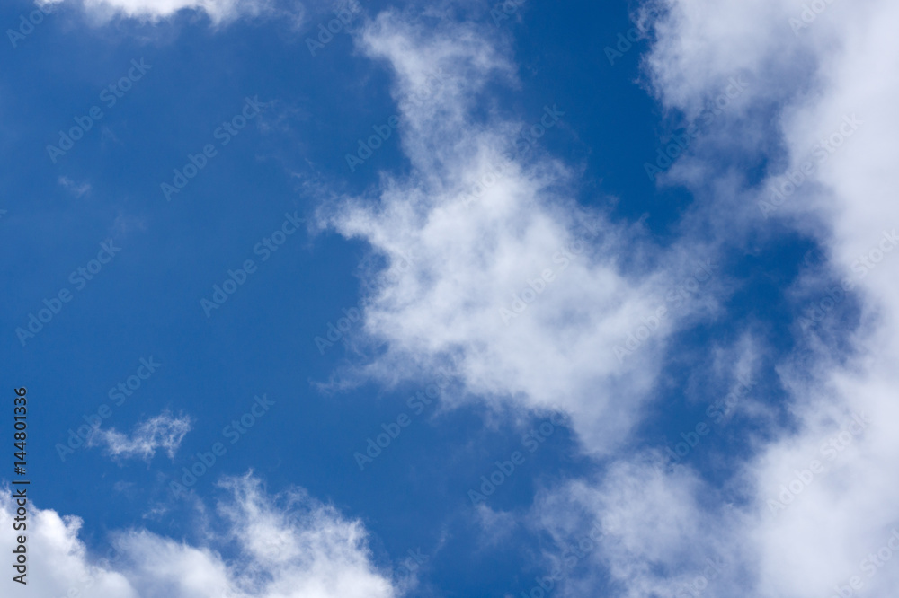 Evening clouds on the background of the blue sky.