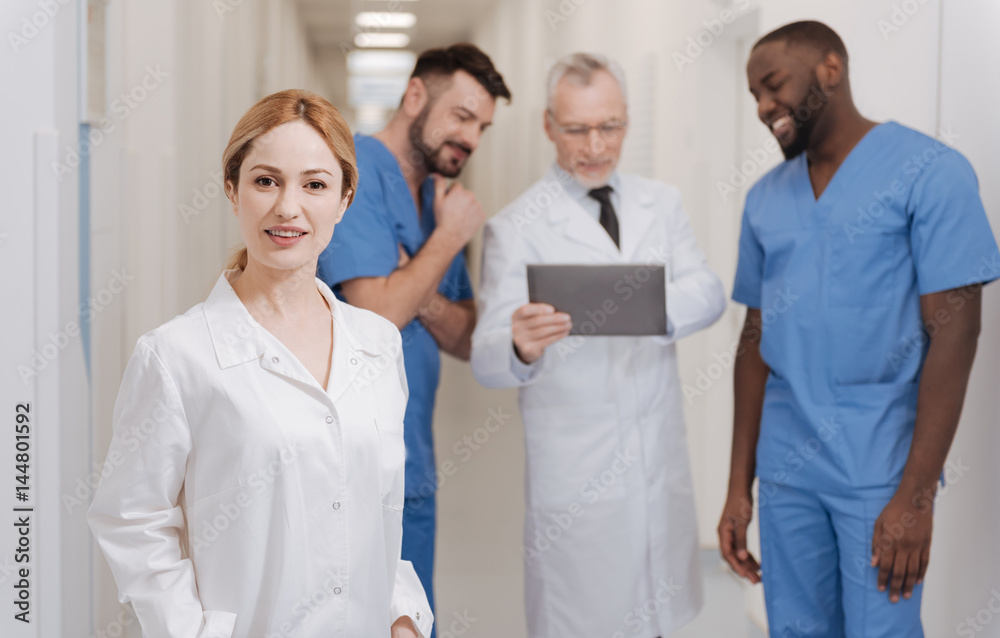 Young charming nurse standing in the hospital Young charming nurse standing in the hospital