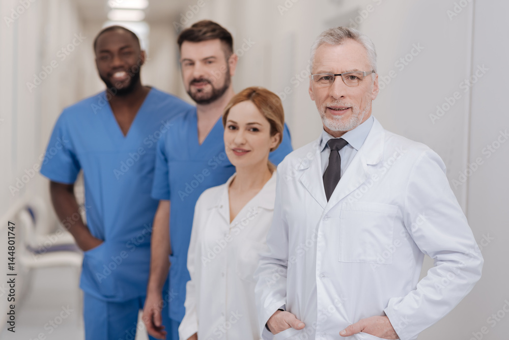 Aged doctor enjoying working hours in the clinic Aged doctor enjoying working hours in the clinic