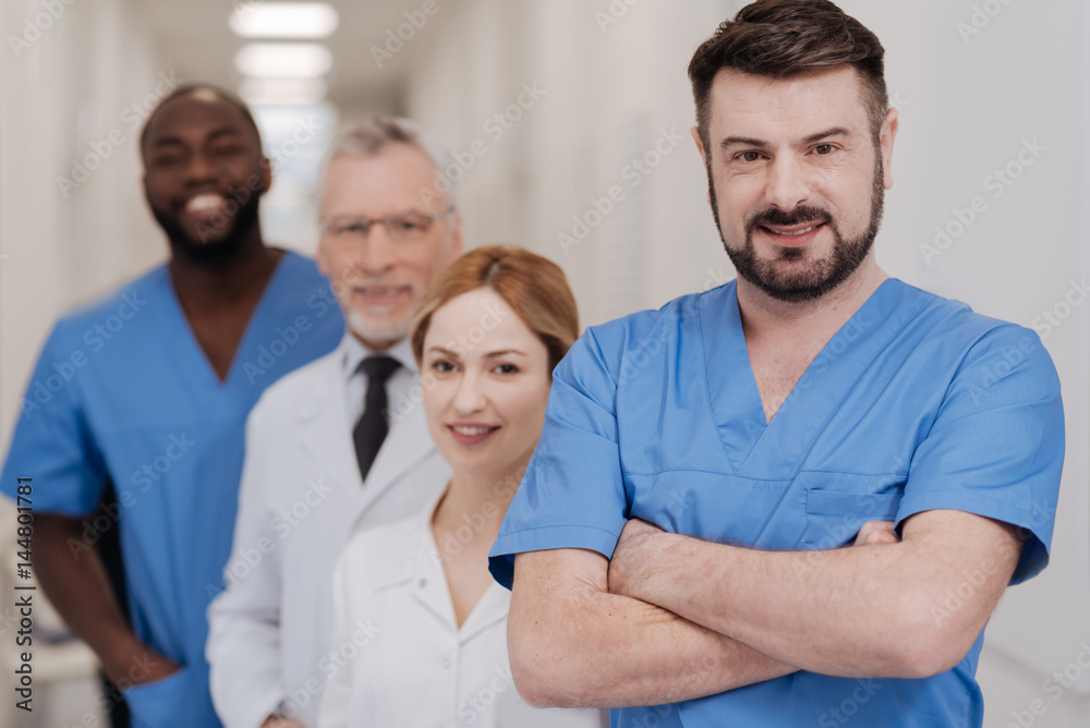 Fototapeta premium Mature practitioner expressing joy in the hospital