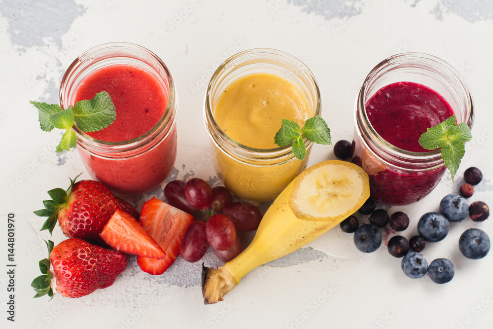 Bright summer smoothies in glass jars Bright summer smoothies in glass jars