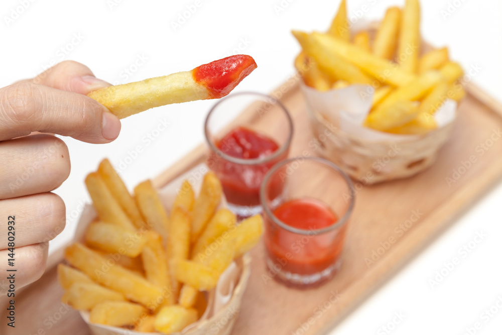 Eating french fries dipping with ketchup and chili sauce