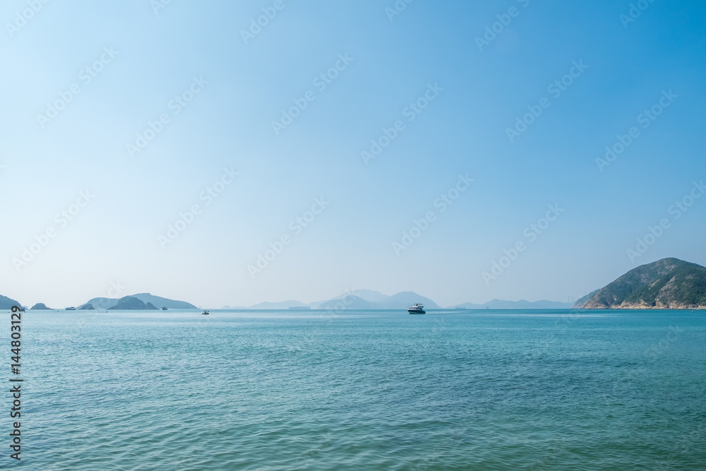 Landscape view of sea ocean with speed boat and mountain in sunny day