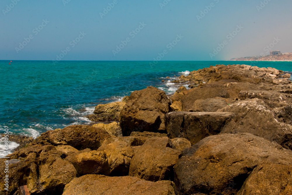 Beautiful seashore with breakwater and large stones