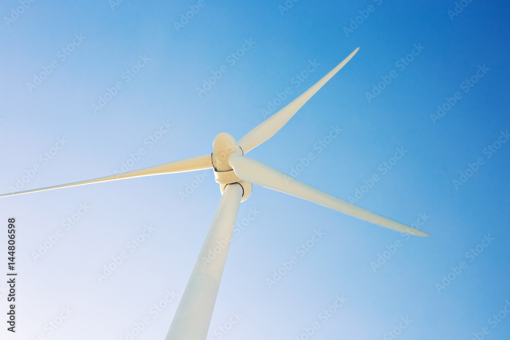 Wind turbine generating electricity with blue sky - energy conservation concept Wind turbine generating electricity with blue sky - energy conservation concept