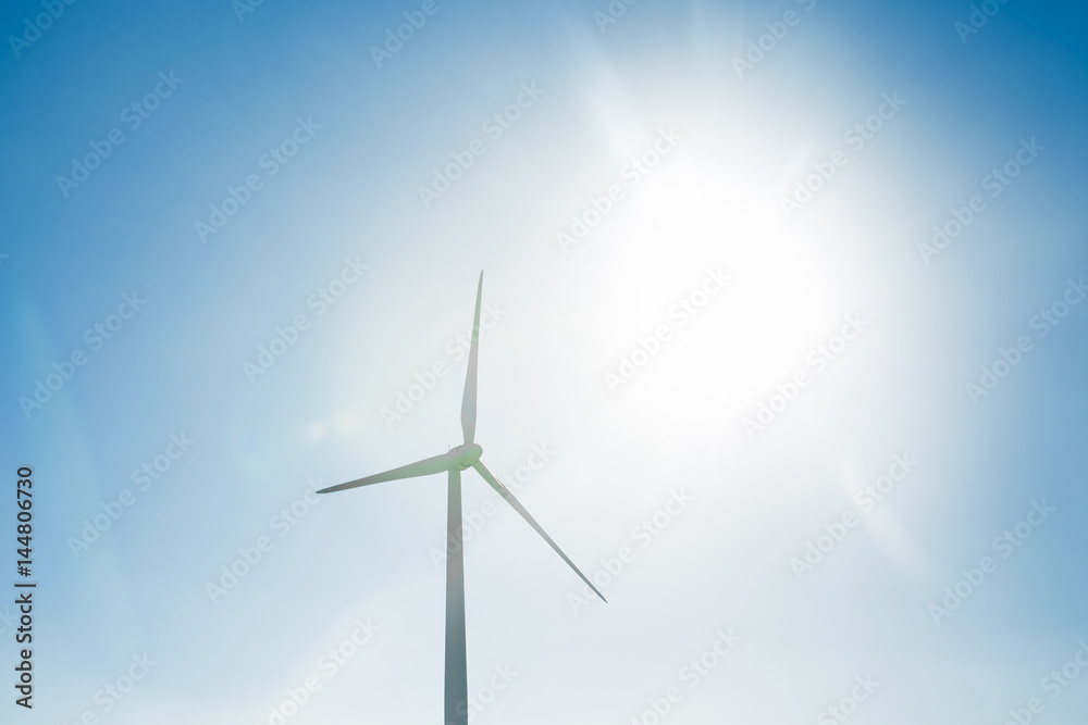 Wind turbine generating electricity with blue sky - energy conservation concept Wind turbine generating electricity with blue sky - energy conservation concept